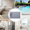 A rectangular, non-slip bath mat with a dolphin design is shown in a bathroom setting.