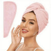 A woman wearing a pink microfiber hair towel wrap on her head.