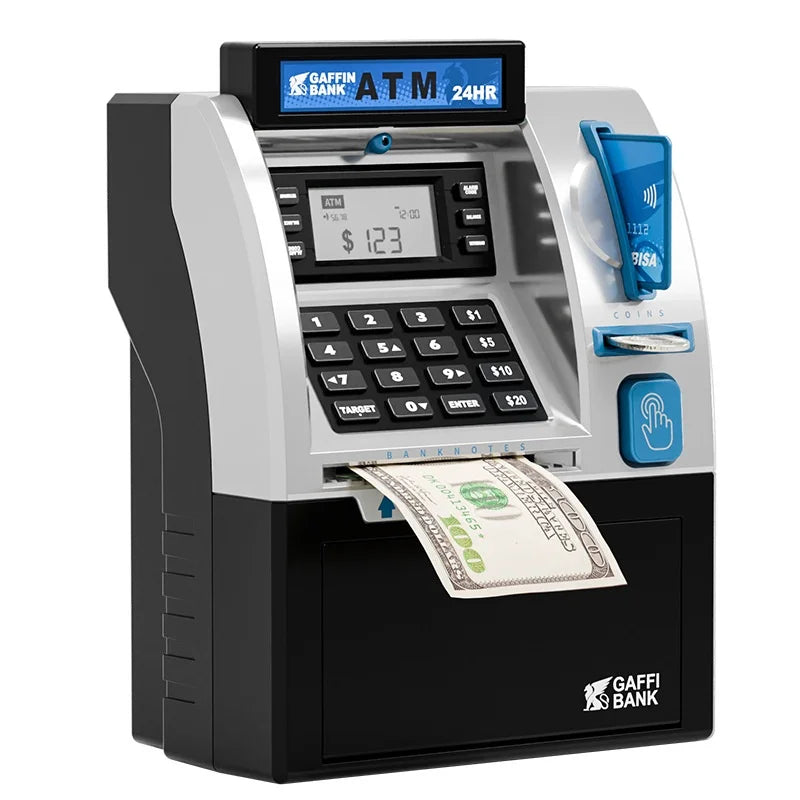 A silver and black ATM-style digital money box for kids with a cash slot and keypad.