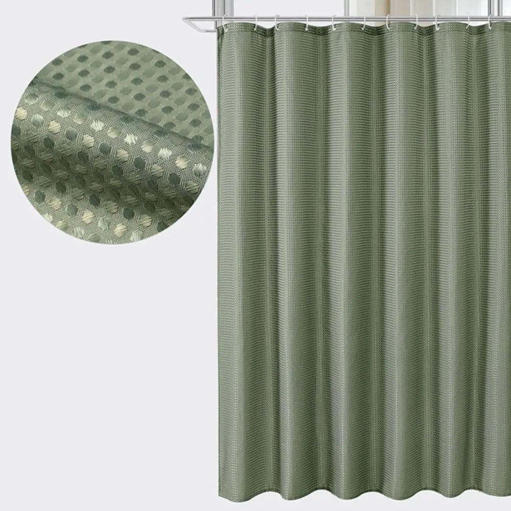 A vertical shower curtain in a muted sage green color with a fine vertical stripe pattern.