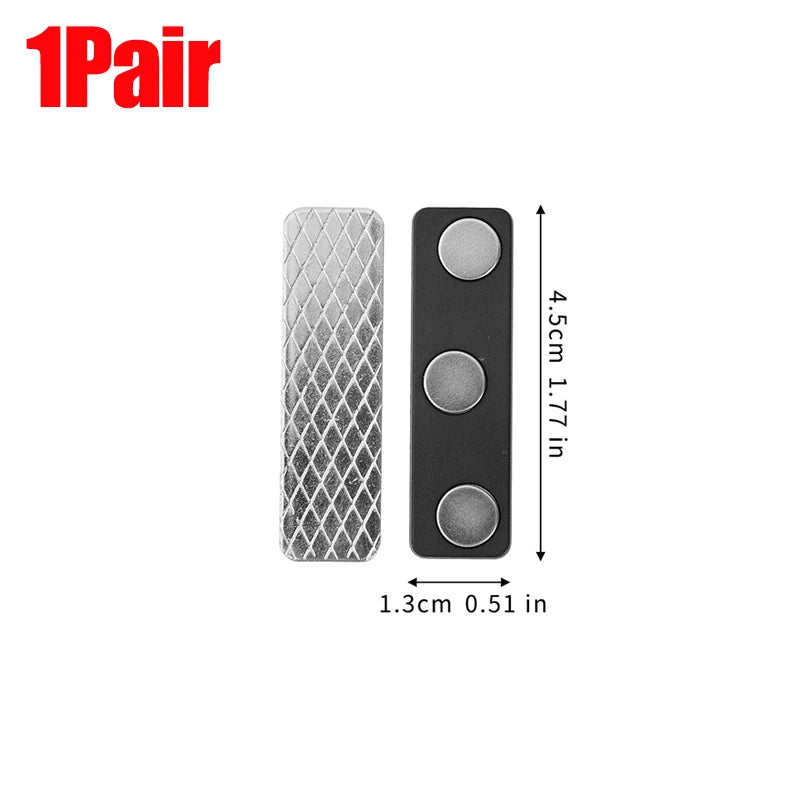 A pair of black magnetic curtain clips with a silver textured backing.
