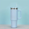 A white 40oz insulated stainless steel tumbler with a handle and straw set against a light blue background.