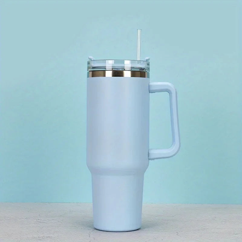 A white 40oz insulated stainless steel tumbler with a handle and straw set against a light blue background.