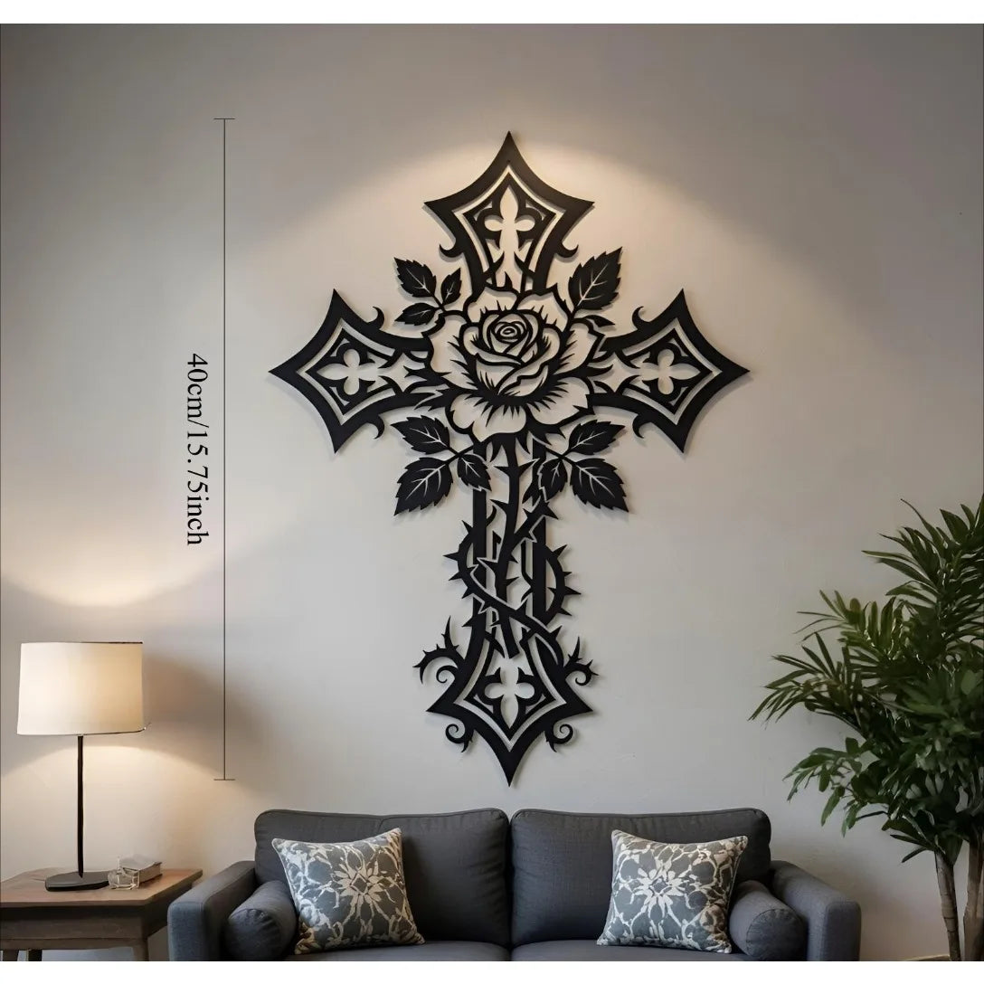 Black metal cross wall art decor with rose and leaf design mounted on a light gray wall.