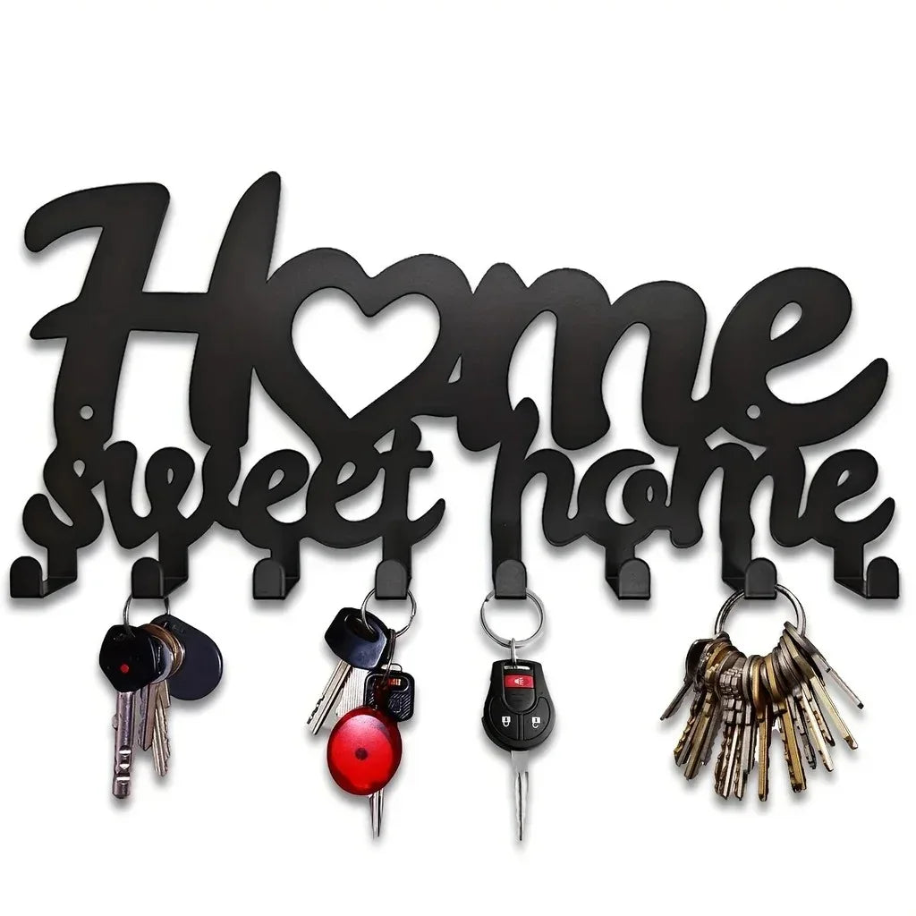 Black decorative metal key holder rack with hooks for keys and keys.