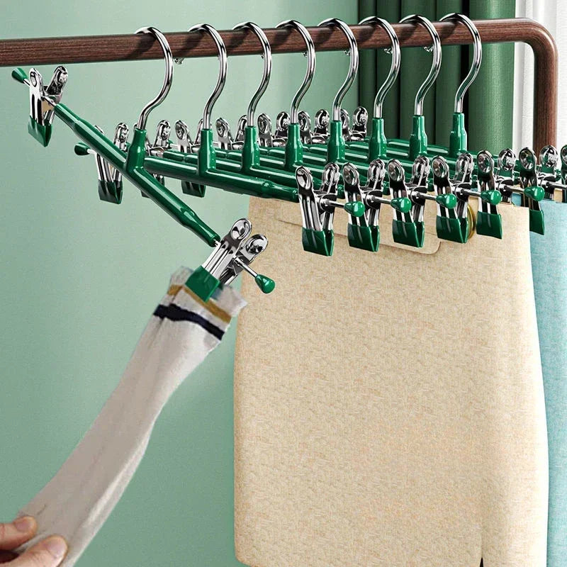 Stainless steel adjustable clothing hangers hanging on a wooden rack
