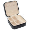 A black portable PU leather jewelry storage box with a hinged lid and divided compartments.