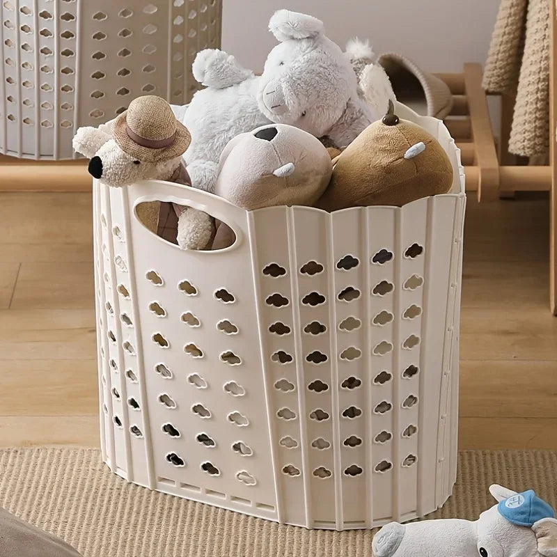 A white folding hand-held clothes storage basket filled with soft stuffed toys.