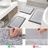 A set of gray microfiber bath mats shown next to a toilet and sink, with a comparison showing easy shedding versus other mate