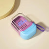 A leakproof travel container in purple and light blue plastic is shown on a beige surface.
