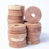 A stack of natural wood blocks used as pest deterrents, showing various shades and cuts of light wood.