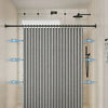 A gray magnetic shower curtain with a waffle texture hanging in a bathroom.