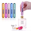 A hand holds a pink perfume bottle and five matching refillable spray bottles in various colors like gold, purple, and green.