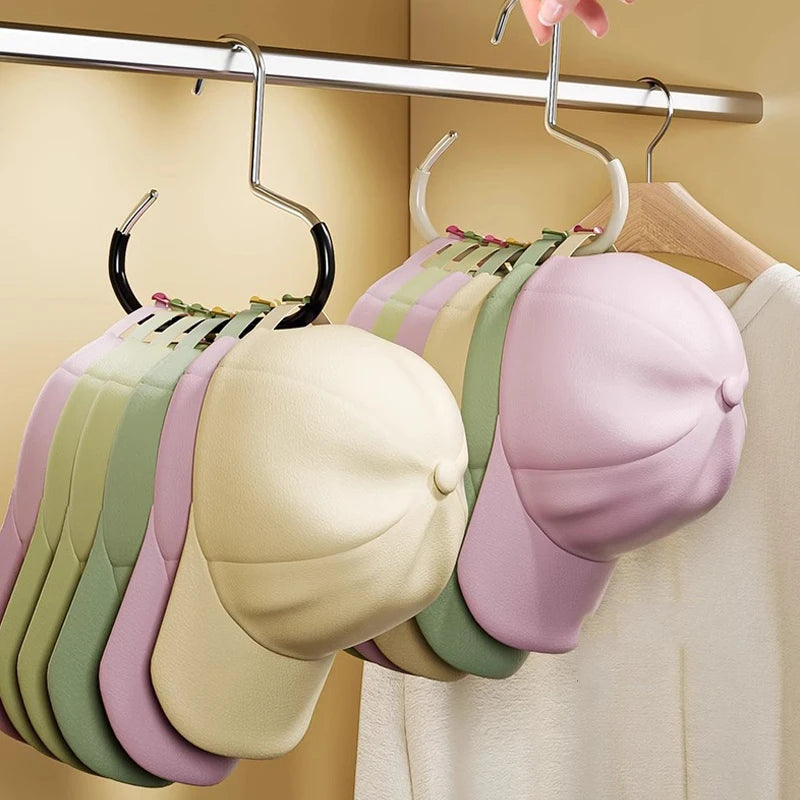 A display of various colored fabric hats hanging from a metal hanger rack.