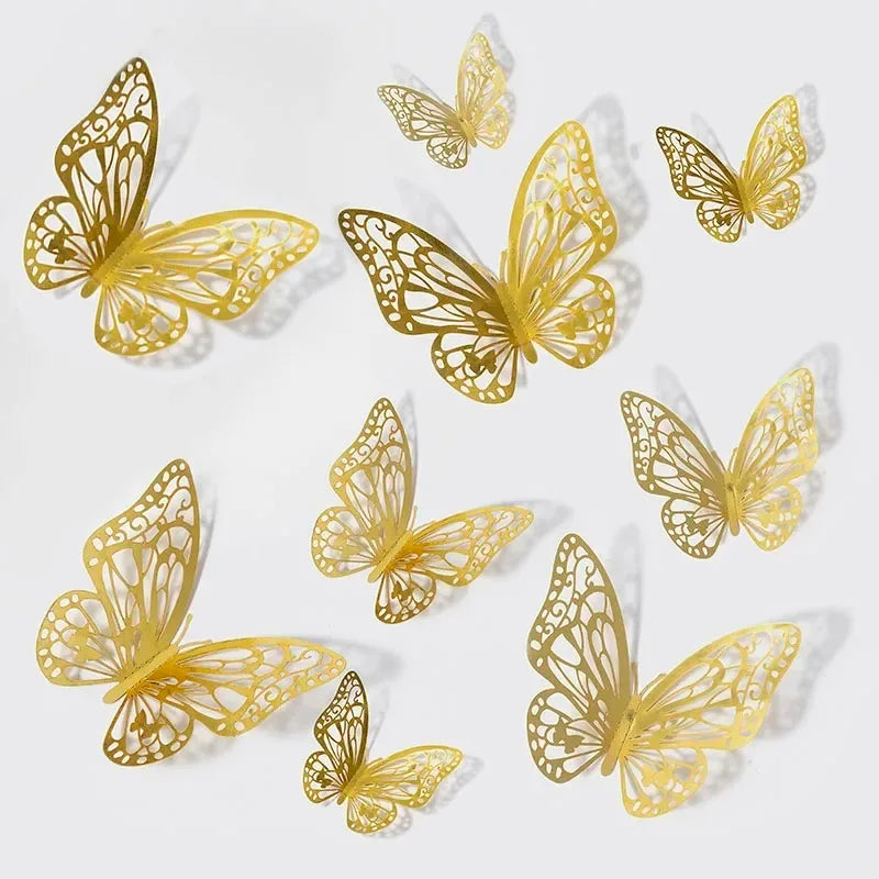 A collection of gold-colored, intricate 3D decorative butterfly wall stickers scattered on a white background.