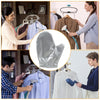A woman is using heat resistant garment steamer mitts to steam a shirt on a hanger.
