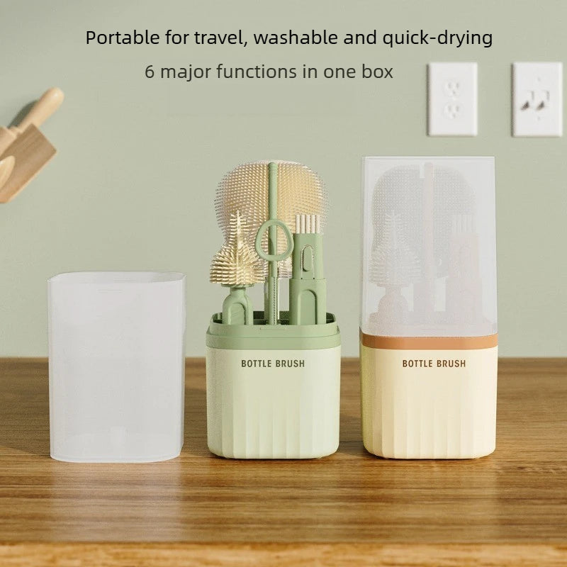 A set of portable silicone bottle brushes and a drying rack displayed on a wooden surface.