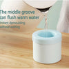 A white silicone ice cube mold is shown with warm water being flushed through the middle groove.