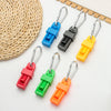 A collection of colorful durable glove clips with metal clasps arranged next to a woven mat.