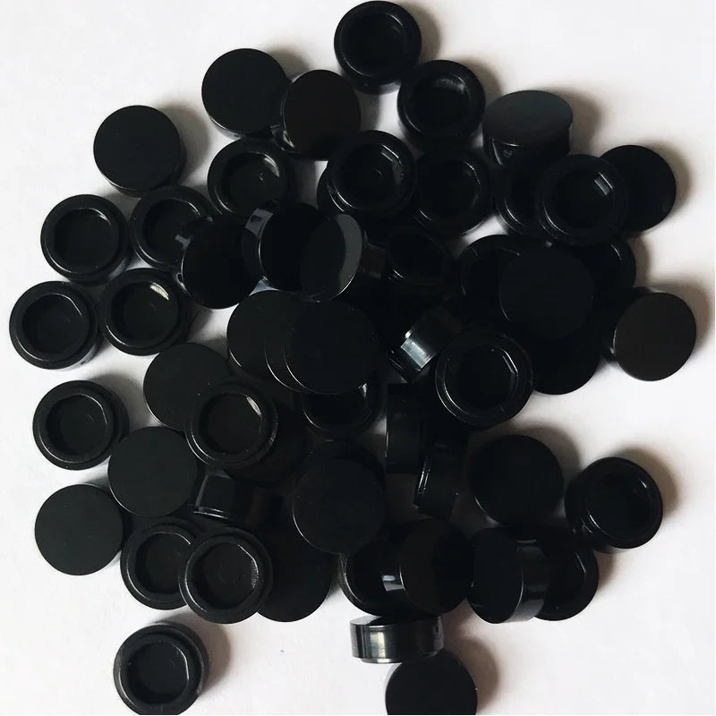 A pile of round black building blocks for DIY projects.