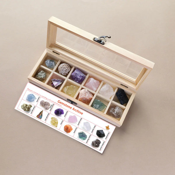 A wooden box containing a collection of various colored quartz crystal stones, including amethyst and citrine.