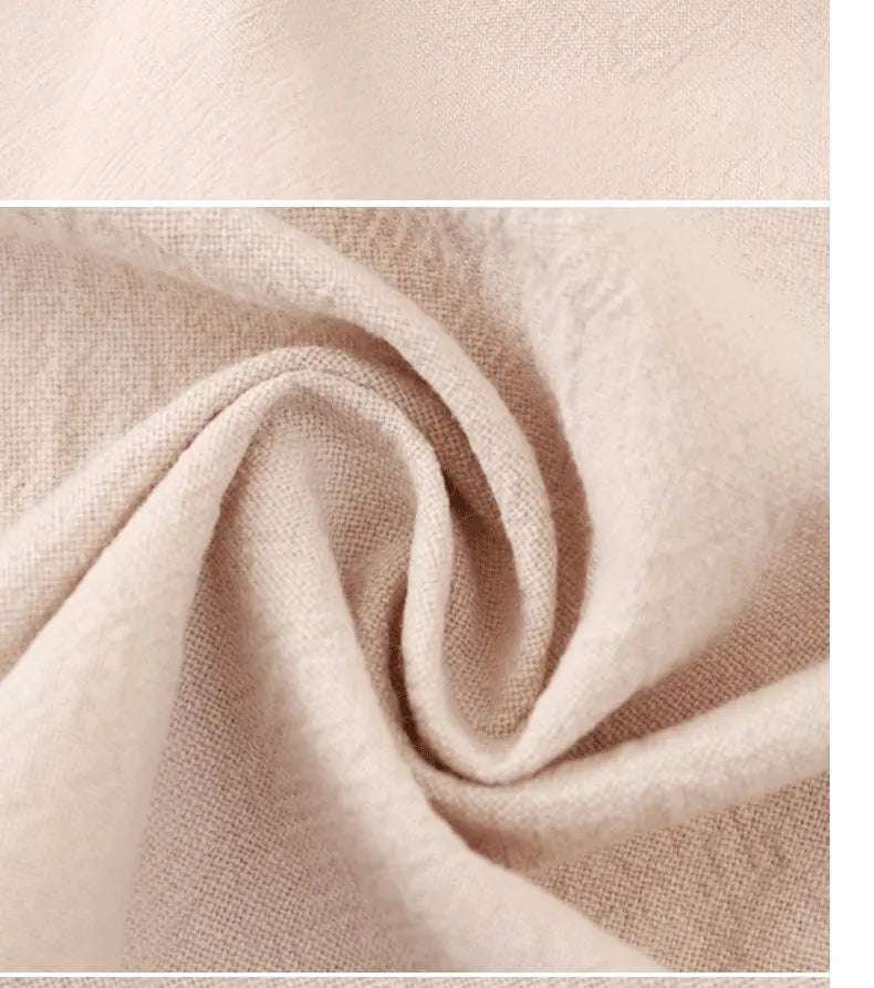 Close-up of a beige cotton kitchen apron fabric showing soft folds and texture.