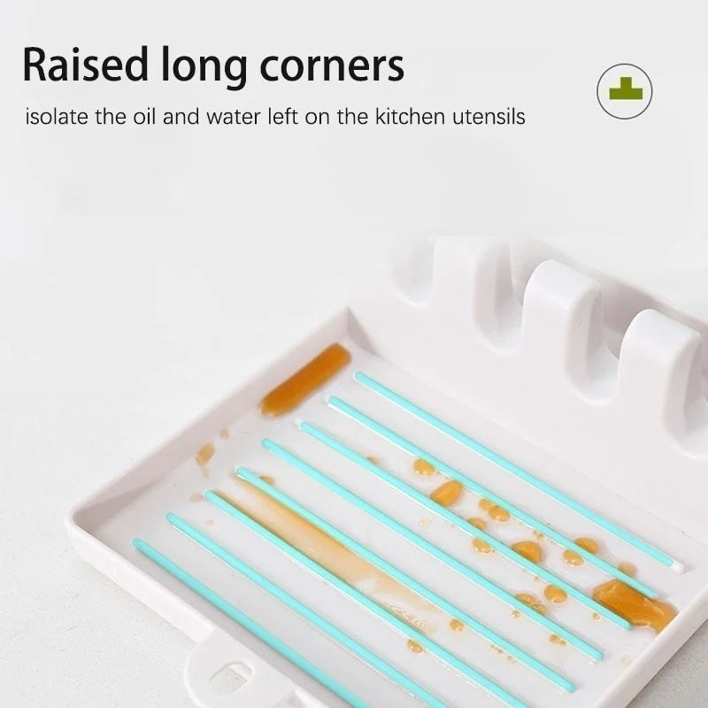 A white kitchen utensil holder with raised long corners designed to isolate oil and water on utensils.