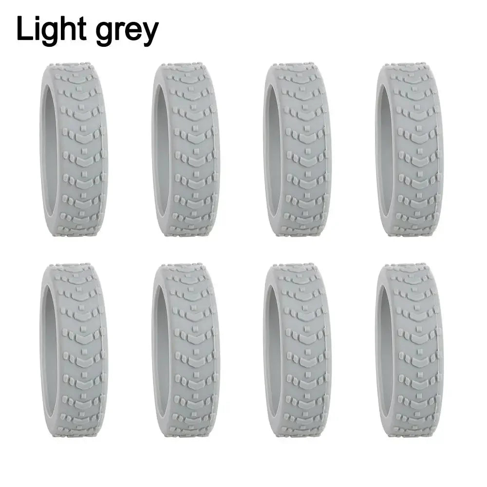 A set of light grey silicone luggage wheel protectors for protection and cushioning.