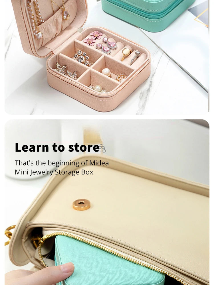 A light pink portable PU leather jewelry storage box with compartments filled with small silver and gold jewelry.