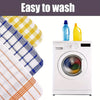 A set of plaid microfiber dish towels next to a white washing machine with cleaning liquids.