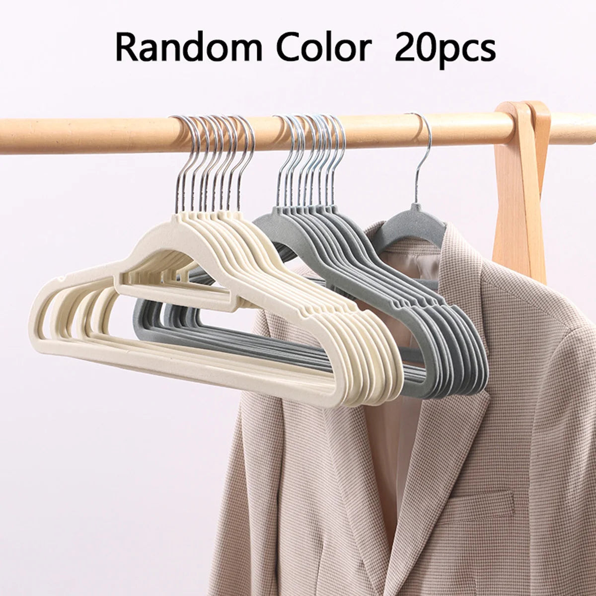 A set of 20 random color velvet slim hangers hanging on a wooden rod.