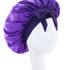 Purple silky satin sleep bonnet tied with a bow displayed on a white mannequin head.