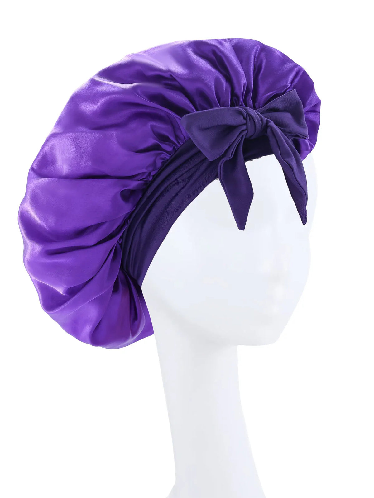 Purple silky satin sleep bonnet tied with a bow displayed on a white mannequin head.