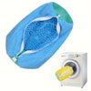 A bright blue durable mesh shoe wash bag with a zipper is shown next to a washing machine.