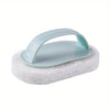 Light blue magic sponge scrubber with an ergonomic handle resting on a white foam pad