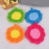 Four brightly colored felt dish towels in green, blue, orange, and pink arranged on a white surface.