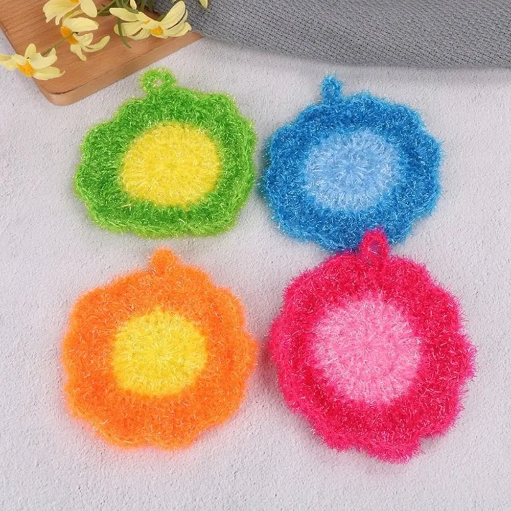 Four brightly colored felt dish towels in green, blue, orange, and pink arranged on a white surface.