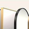 A display of full length arch mirrors with black and gold aluminum frames.