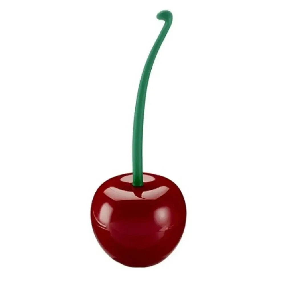A decorative cherry-shaped toilet brush with a green handle.