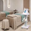 A portable beauty trolley cart with a light beige color is shown in a bright room.