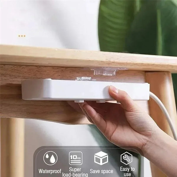 A hand is applying an invisible double-sided adhesive wall hook to a wooden surface, demonstrating its easy to use feature.