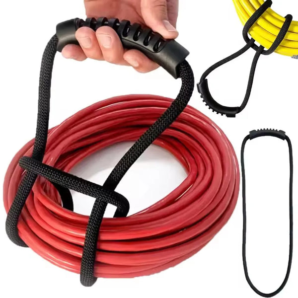A hand is holding a black hook and loop cord, with a coiled red cord and a yellow cord visible nearby.