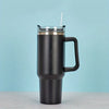 A black insulated stainless steel tumbler with a handle and straw is shown against a light blue background.
