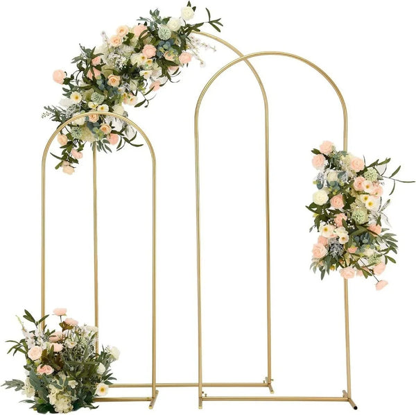 A gold arch stand with floral greenery and white flowers for party decor.