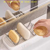 Stainless steel rack holding and displaying natural soap bars on a marble countertop