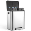 A stainless steel dual compartment trash can with a black lid and visible trash inside.