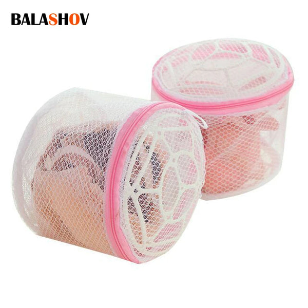 A pink reusable mesh bag used for washing lingerie or delicate items.