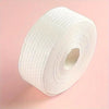 A roll of white professional cotton pads for nail and gel polish removal