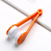 Orange tweezer-style brush set with white microfiber heads for cleaning eyeglasses