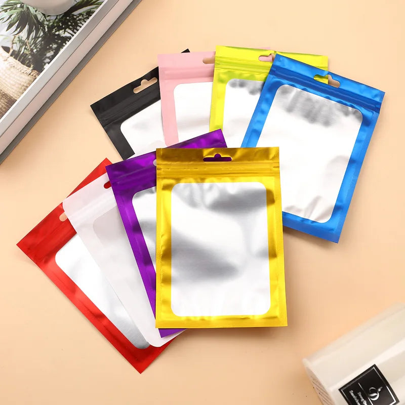 A collection of colorful plastic pouches for jewelry display, including pink, yellow, purple, and blue.